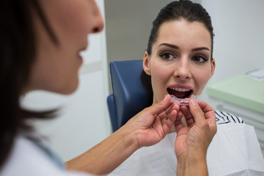 dentist assisting patient wear invisible braces
