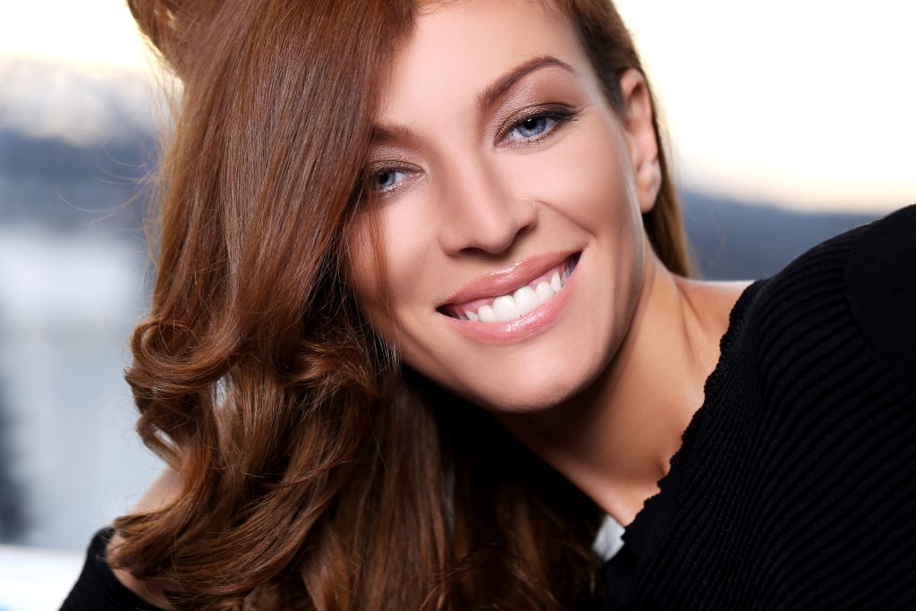 a picture of a women showing cosmetic dental crown