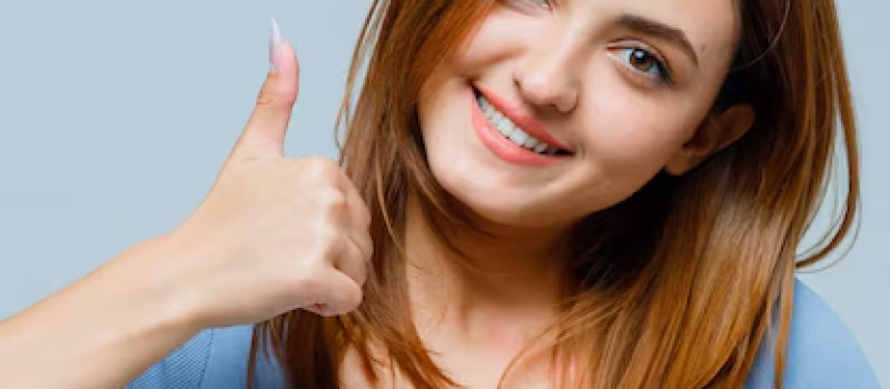 young female patient showing thumbs up